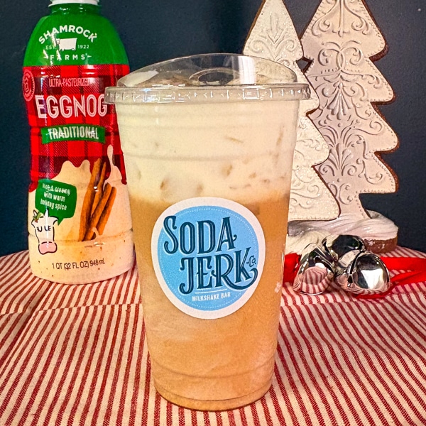 Egg Noggin' Whiz Bang Soda in a Soda Jerk cup with a bottle of eggnog.
